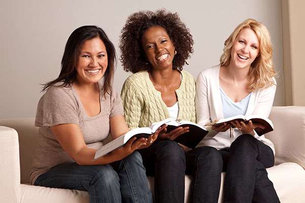 3 of the women reading the Bible with joyness