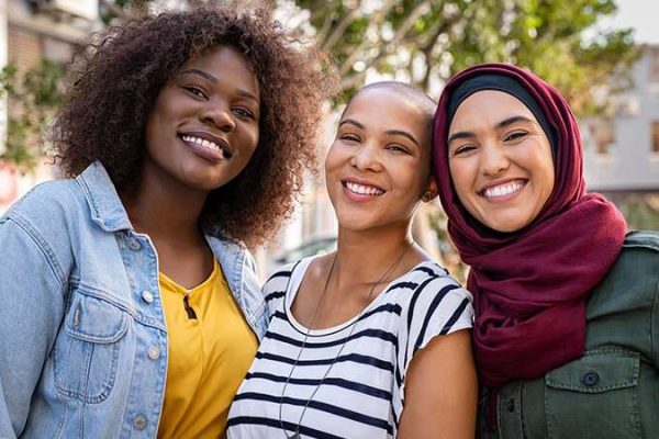 3 Women's smiling at the camera